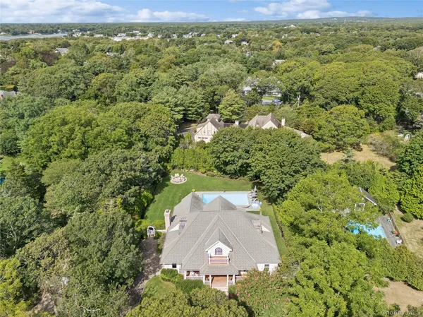 a aerial view of a house with a yard and large tree
