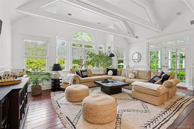 a living room with furniture potted plant and a large window