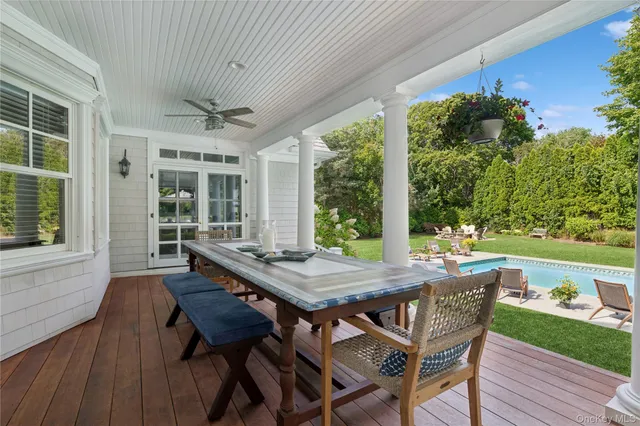 a view of a patio with a table chairs and a backyard