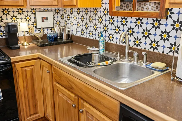 a bedroom with a bed and a dresser next to a window