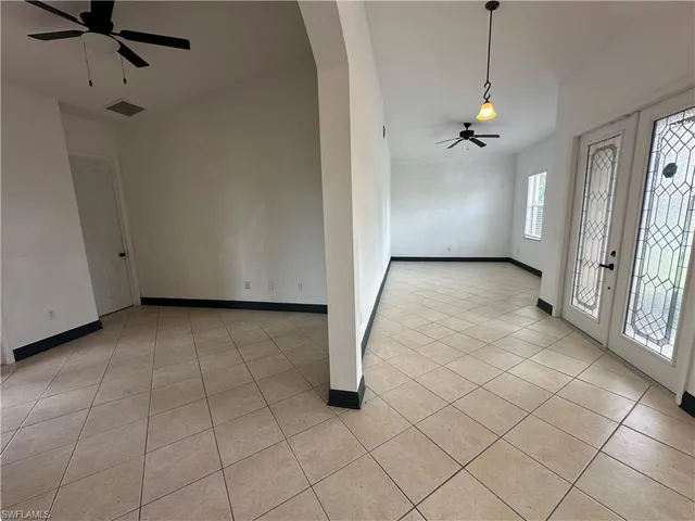 a view of a livingroom with a ceiling fan and entryway