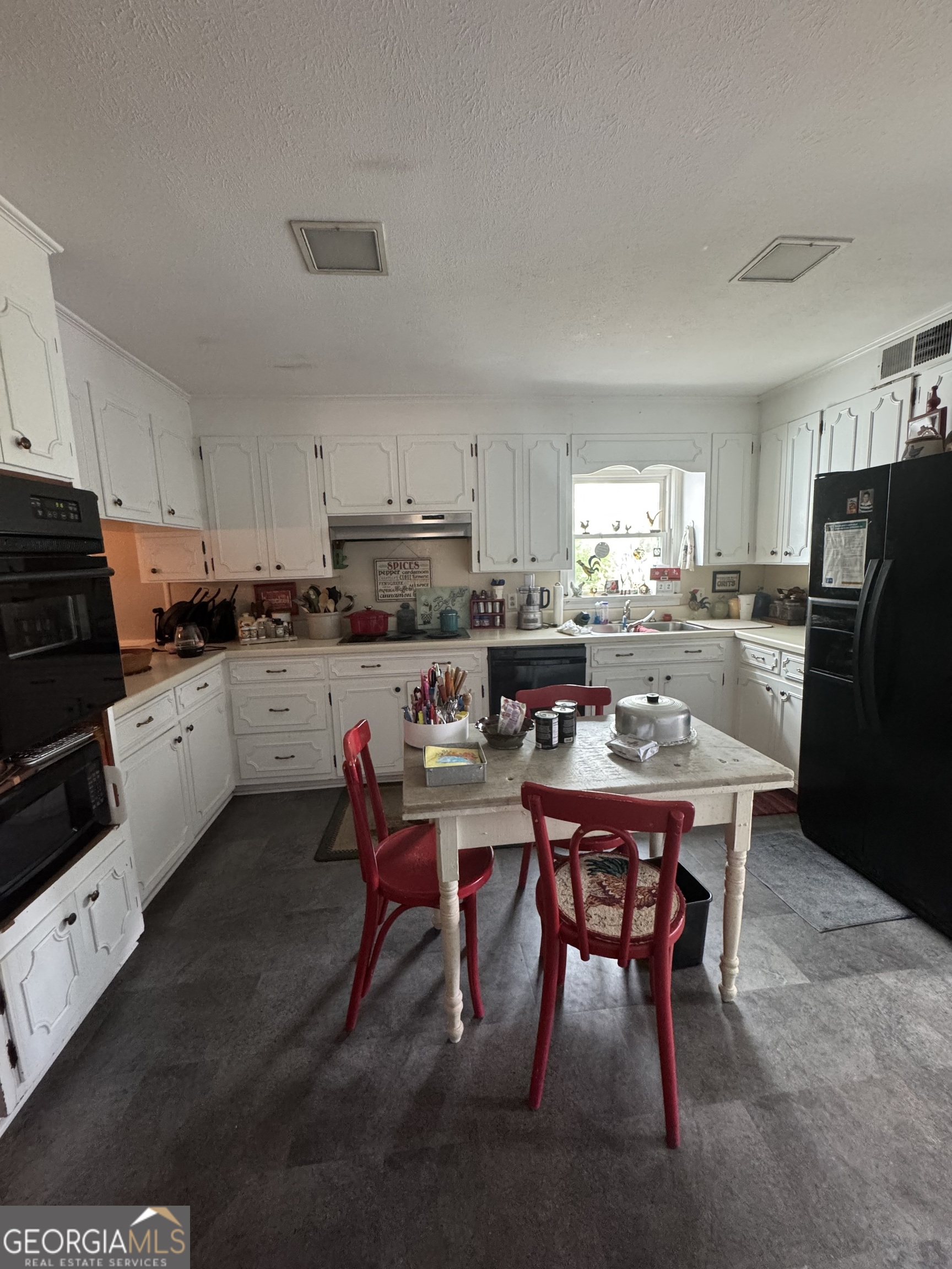 255 Highway 27 Georgetown, GA 39854 - Photo 13 of 16 a kitchen with stainless steel appliances kitchen island granite countertop a dining table chairs refrigerator and sink