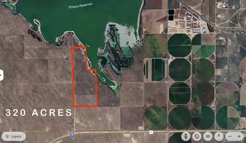 an aerial view of a house with backyard