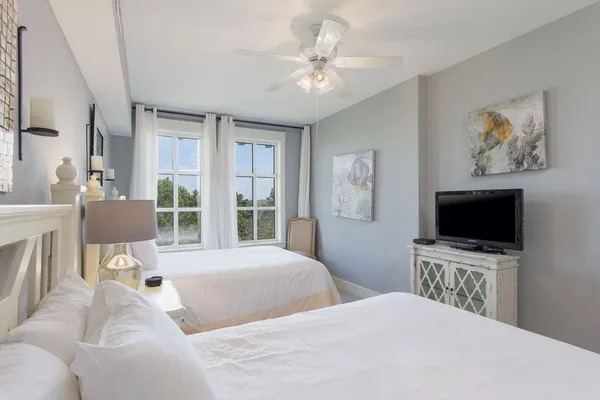 a bedroom with a bed and a flat screen tv