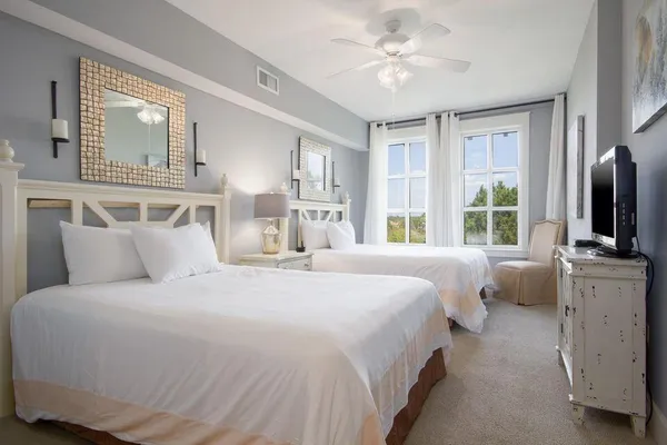 a bedroom with a large bed and flat tv