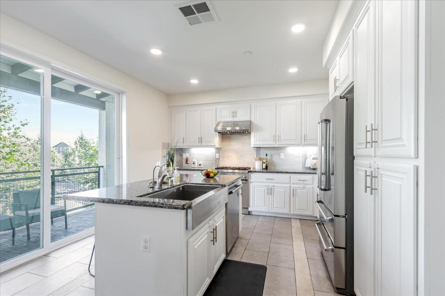 1653 Centre Pointe Drive Milpitas, CA 95035 - Photo 11 of 40 a kitchen with a sink stainless steel appliances and cabinets