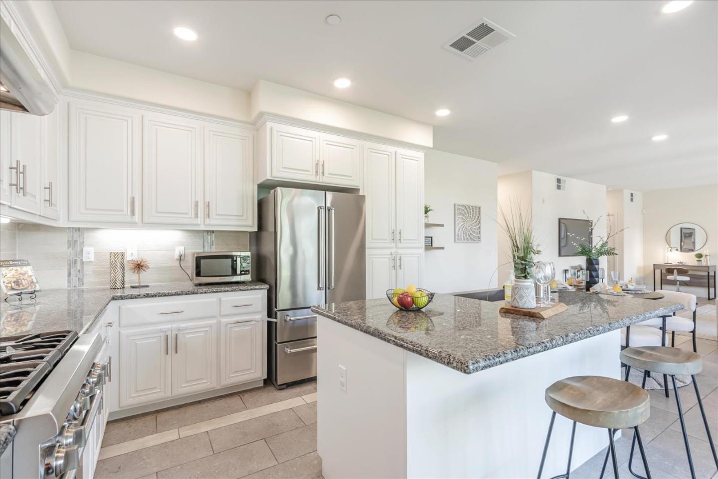 1653 Centre Pointe Drive Milpitas, CA 95035 - Photo 13 of 40 a kitchen with a refrigerator a stove a sink and chairs