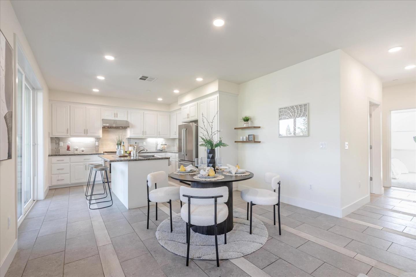 1653 Centre Pointe Drive Milpitas, CA 95035 - Photo 15 of 40 a kitchen with stainless steel appliances kitchen island granite countertop a table and chairs in it