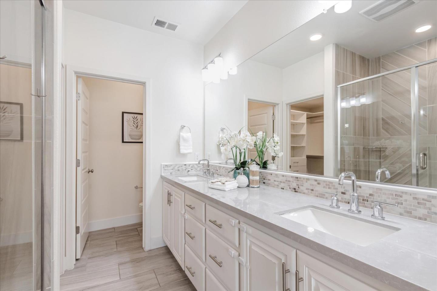 1653 Centre Pointe Drive Milpitas, CA 95035 - Photo 19 of 40 a bathroom with double sink and a mirror