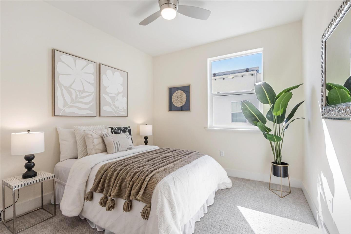 1653 Centre Pointe Drive Milpitas, CA 95035 - Photo 21 of 40 a bedroom with a bed and a potted plant