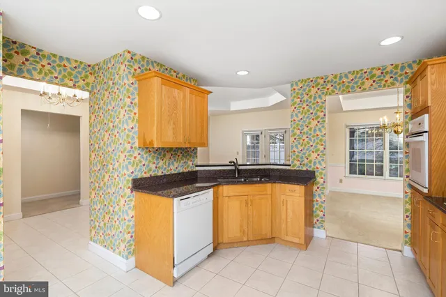 a kitchen with granite countertop a sink and cabinets