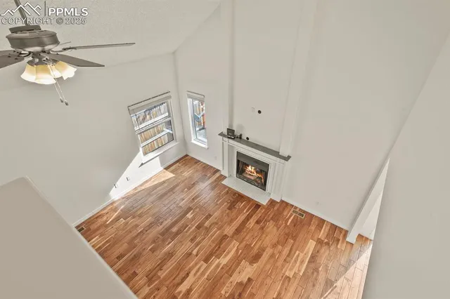 a view of a bedroom with wooden floor