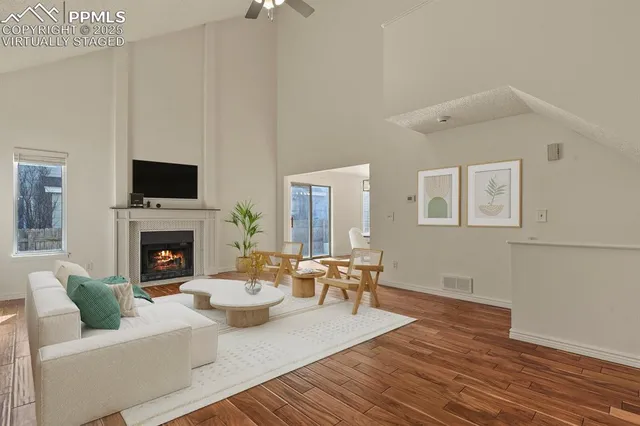 a living room with furniture a fireplace and a flat screen tv