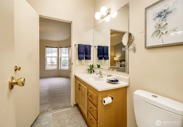 a bathroom with a sink a toilet and mirror