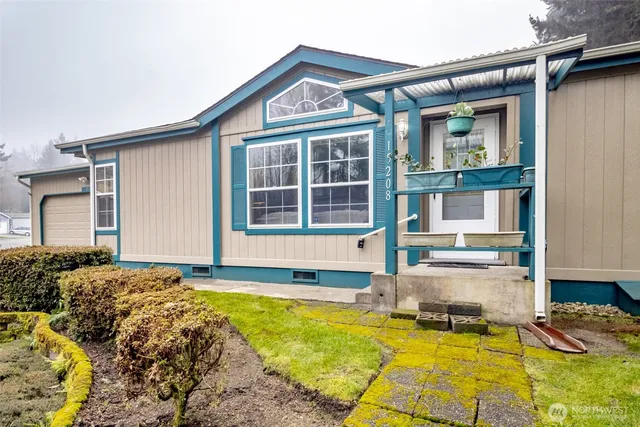 a front view of a house with yard and swimming pool