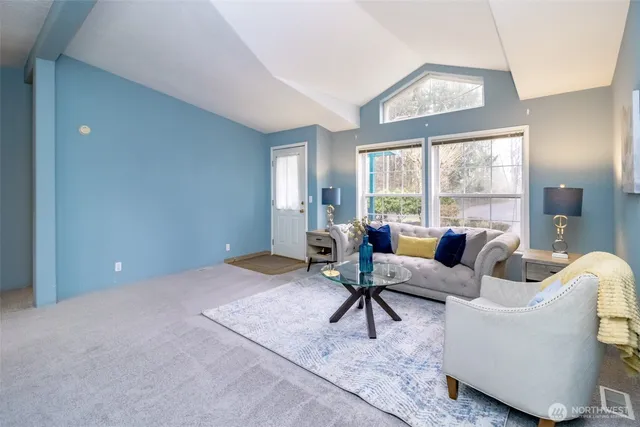 a living room with furniture and a large window