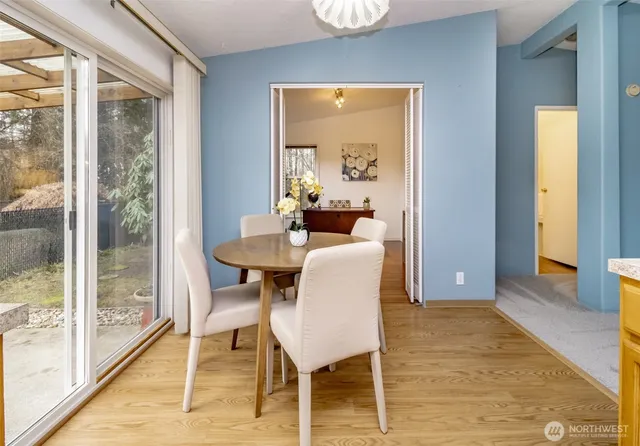 a dining room with furniture and wooden floor