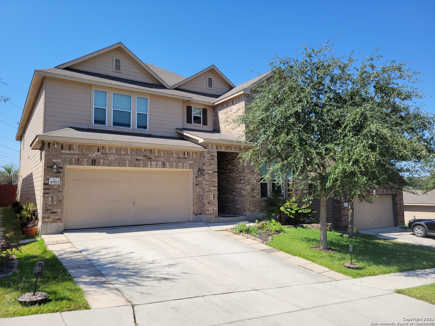 a front view of a house with a yard and garage