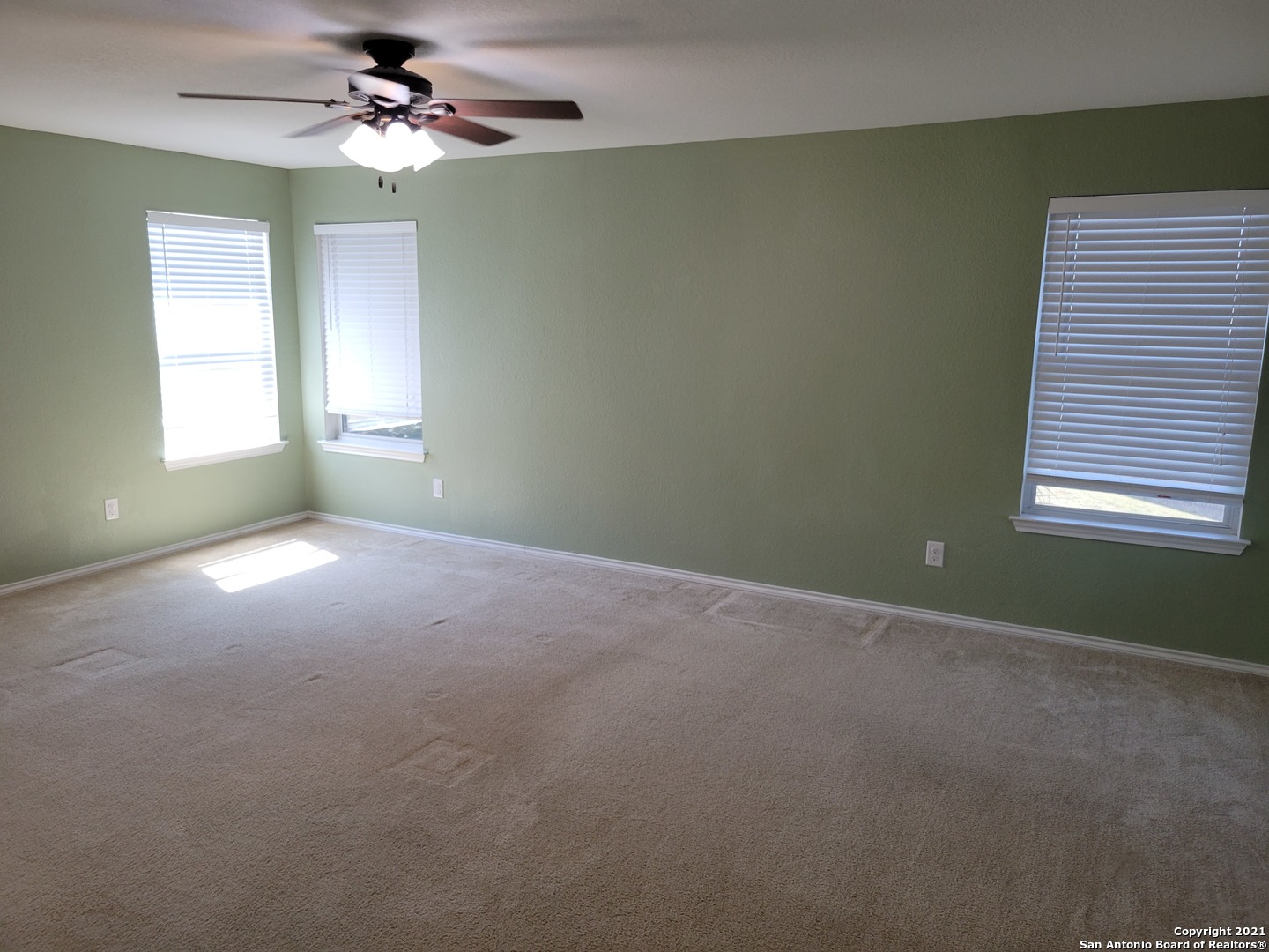 10919 Fox Crest Live Oak, TX 78233 - Photo 13 of 19 a view of a room with windows and ceiling fan