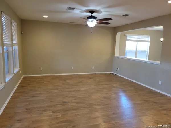 a kitchen with stainless steel appliances granite countertop a sink a counter space and wooden floor