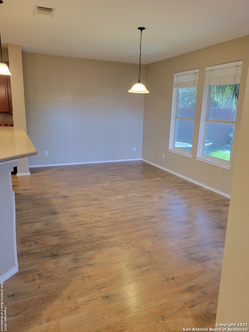 10919 Fox Crest Live Oak, TX 78233 - Photo 7 of 19 a view of an empty room with window and chandelier fan