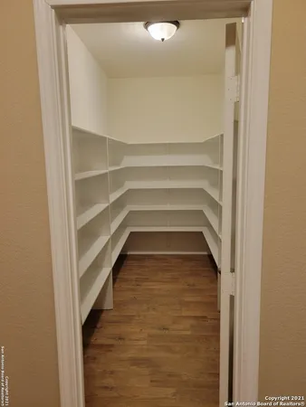 a utility room with wooden floor washer and dryer