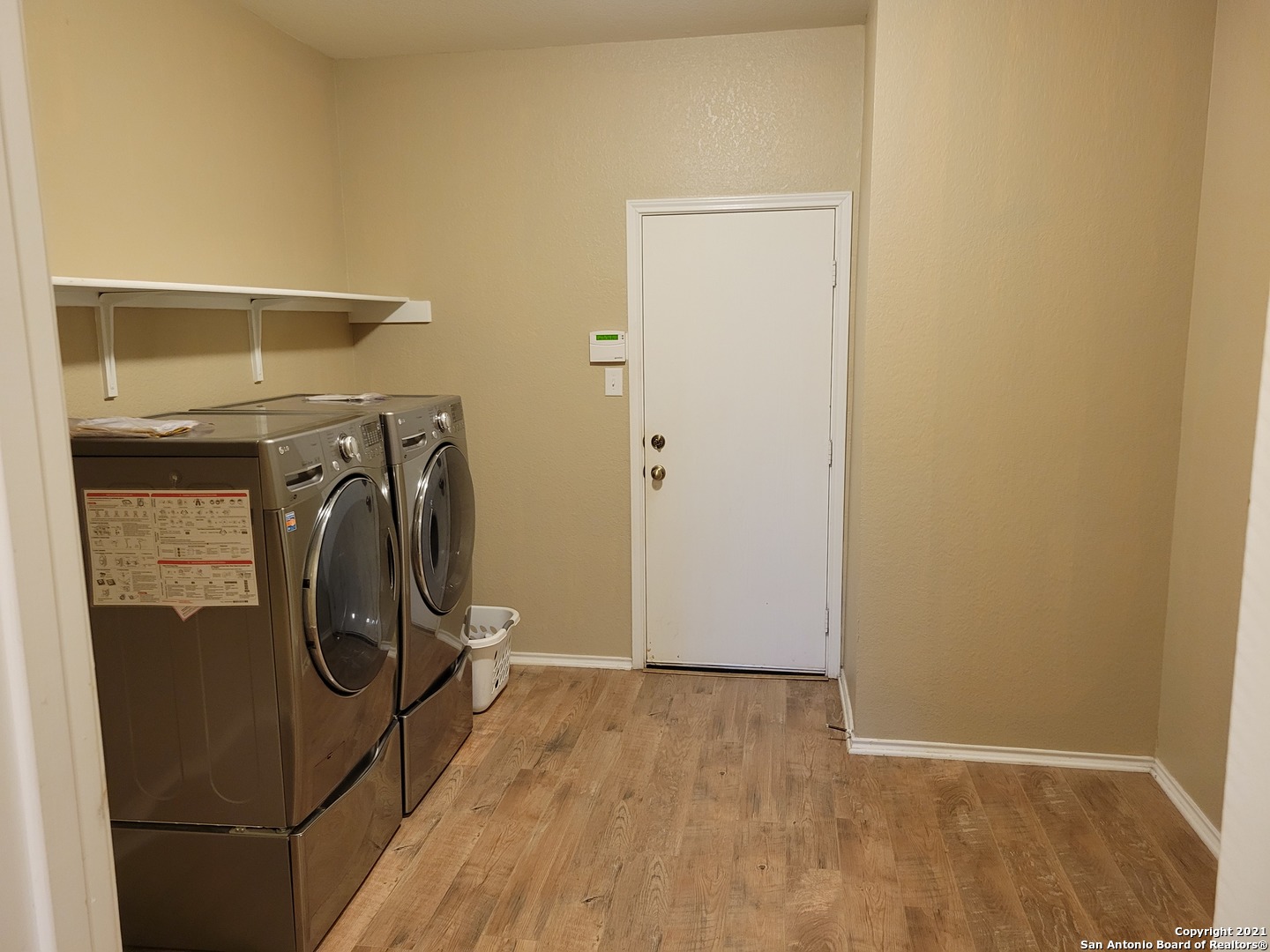 10919 Fox Crest Live Oak, TX 78233 - Photo 10 of 19 a utility room with wooden floor washer and dryer