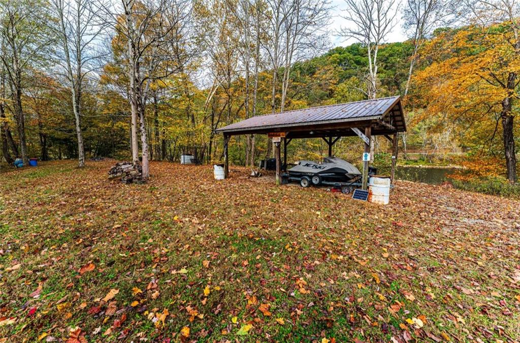 Tbd Tbd Bortz Mine Rd Point Point Marion, PA 15474 - Photo 9 of 25 a view of a patio with table and chairs under an umbrella with large trees