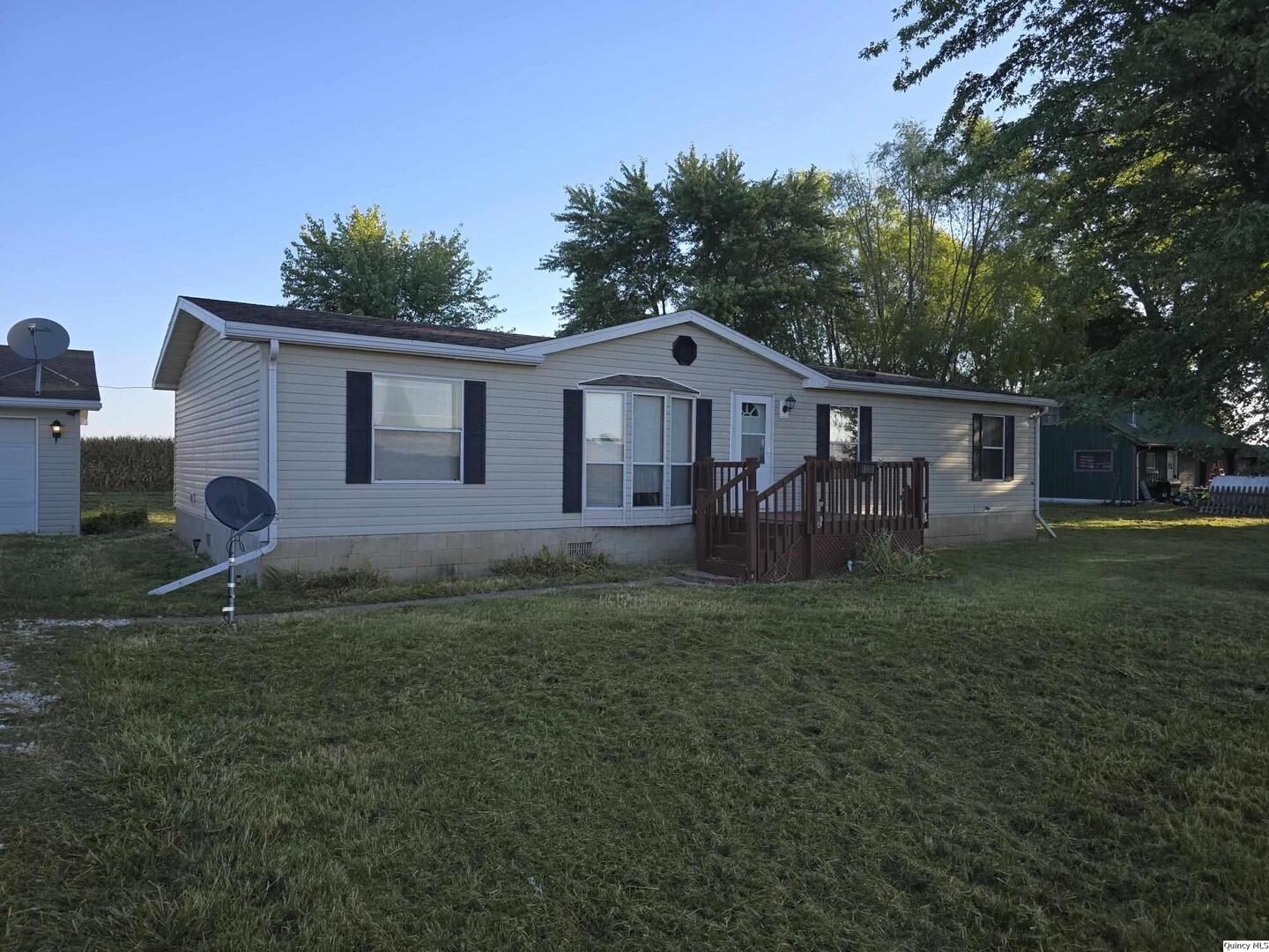 1103 East Main Augusta, IL 62311 - Photo 21 of 27 a view of a yard in front of a house with large trees