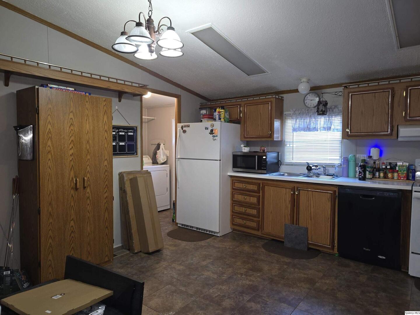 1103 East Main Augusta, IL 62311 - Photo 4 of 27 a kitchen with refrigerator and cabinets