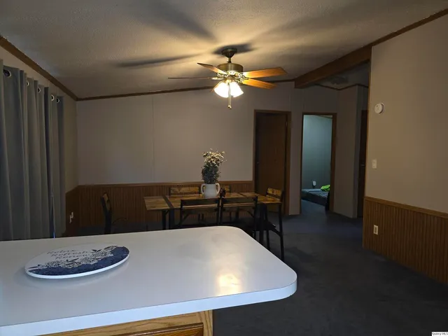 a dining room with a table and chairs