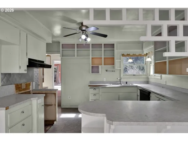 a kitchen with cabinets and window