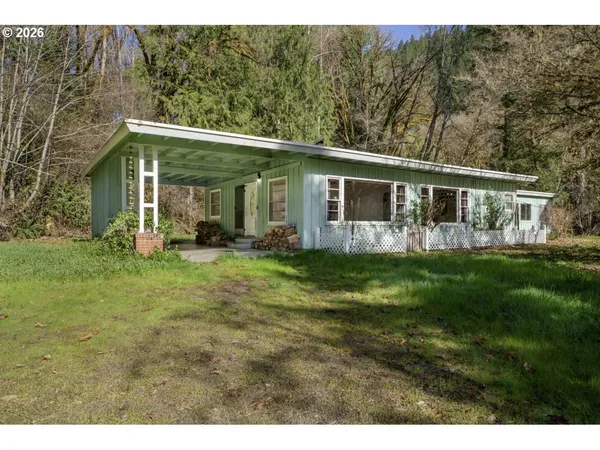 a front view of house with yard and green space