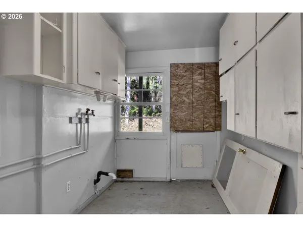 a view of hallway with furniture and a window