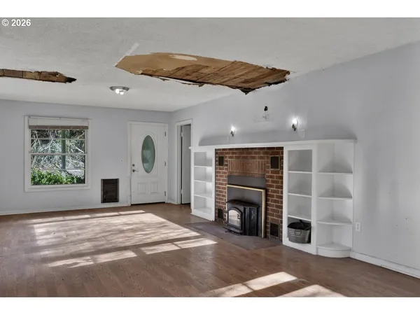 a view of a livingroom with a fireplace and window
