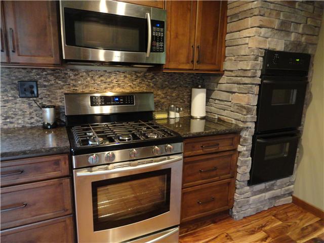 1460 Poplar Ridge Road Chapmansboro, TN 37035 - Photo 10 of 20 Brand new gourmet kitchen! features Samsung stainless appliances, granite counters, glass tile backsplash, new cabinetry, teak hardwood floors, Gorgeous!