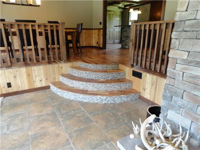 1460 Poplar Ridge Road Chapmansboro, TN 37035 - Photo 17 of 20 New tile in both the huge family room & bonus room/office. Notice the glass tile on the risers of the steps it matches the kitchen backsplash.