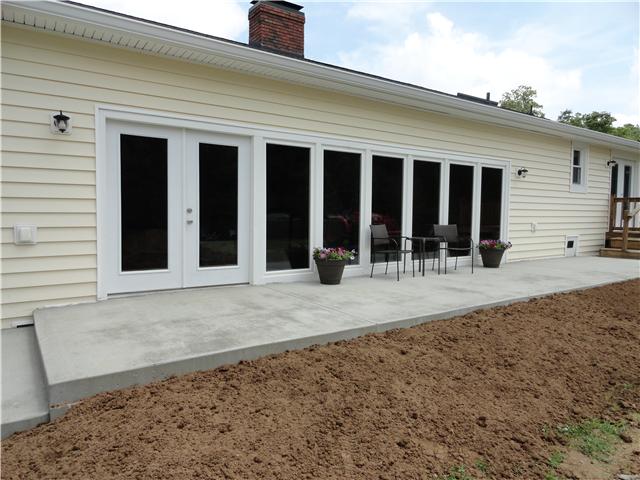 1460 Poplar Ridge Road Chapmansboro, TN 37035 - Photo 19 of 20 This brand new patio & steps have just been added across the back of the home. I bet there will even be new grass by the time you get here!