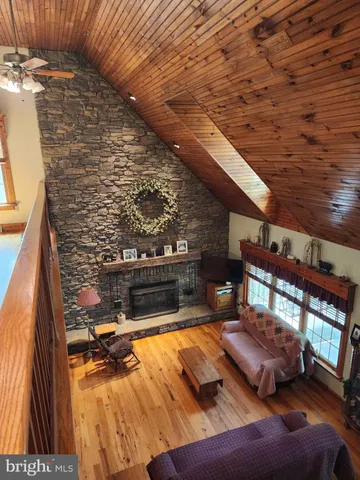 a kitchen with stainless steel appliances granite countertop a sink a stove and wooden cabinets