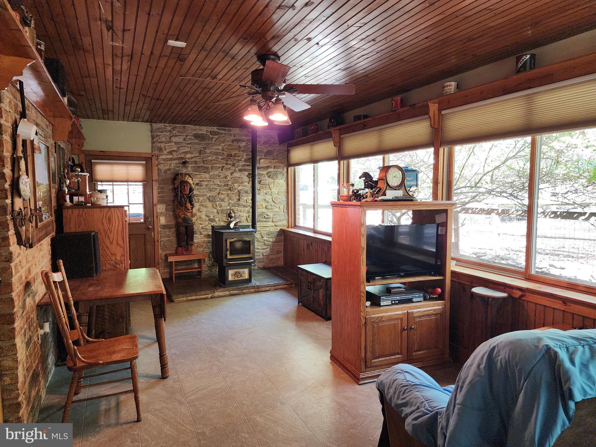 14847 White Oak Ridge Hancock, MD 21750 - Photo 24 of 101 a living room with furniture a flat screen tv and a large window