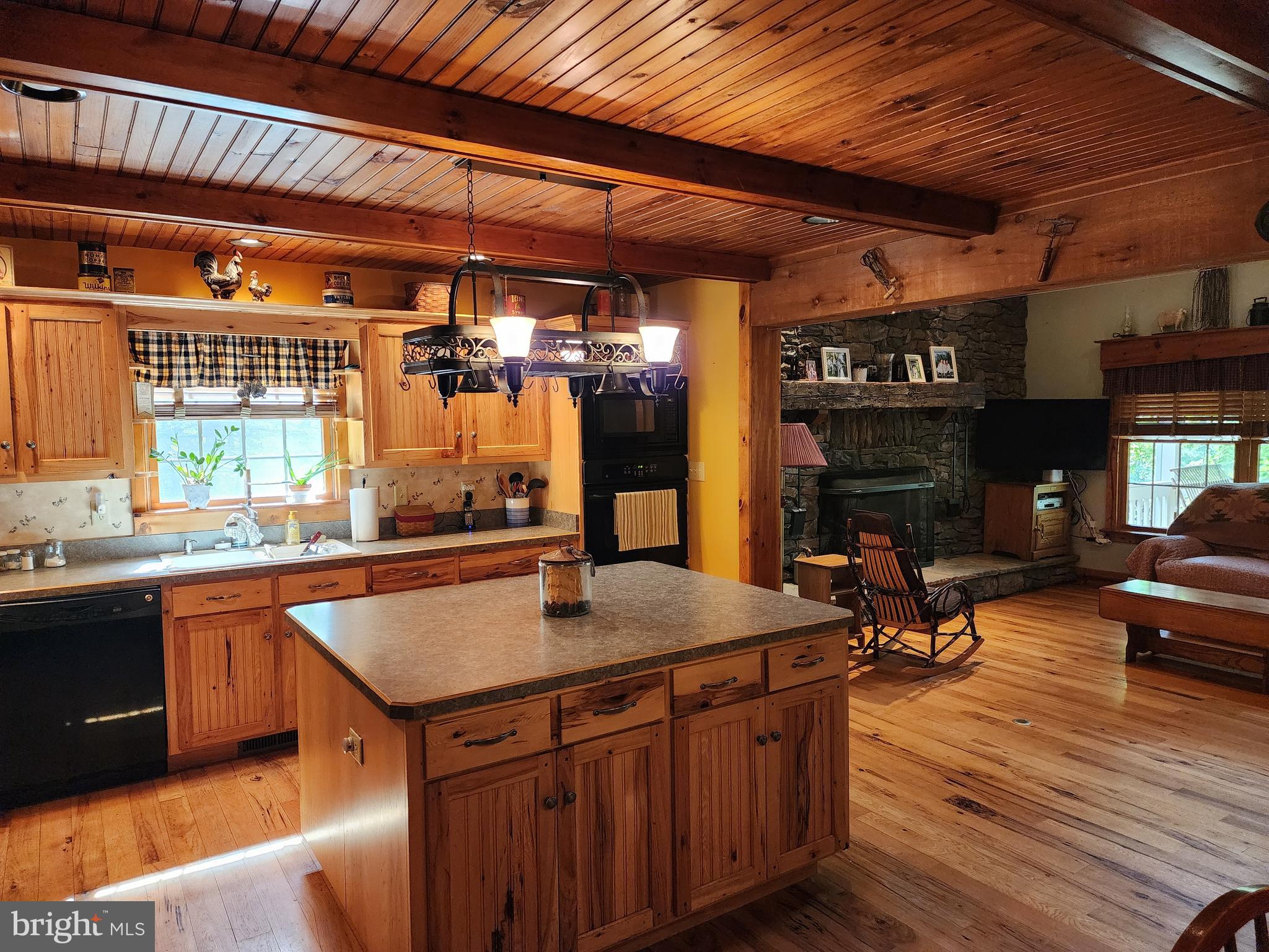 14847 White Oak Ridge Hancock, MD 21750 - Photo 26 of 101 a kitchen with stainless steel appliances granite countertop a sink dishwasher and cabinets with wooden floor