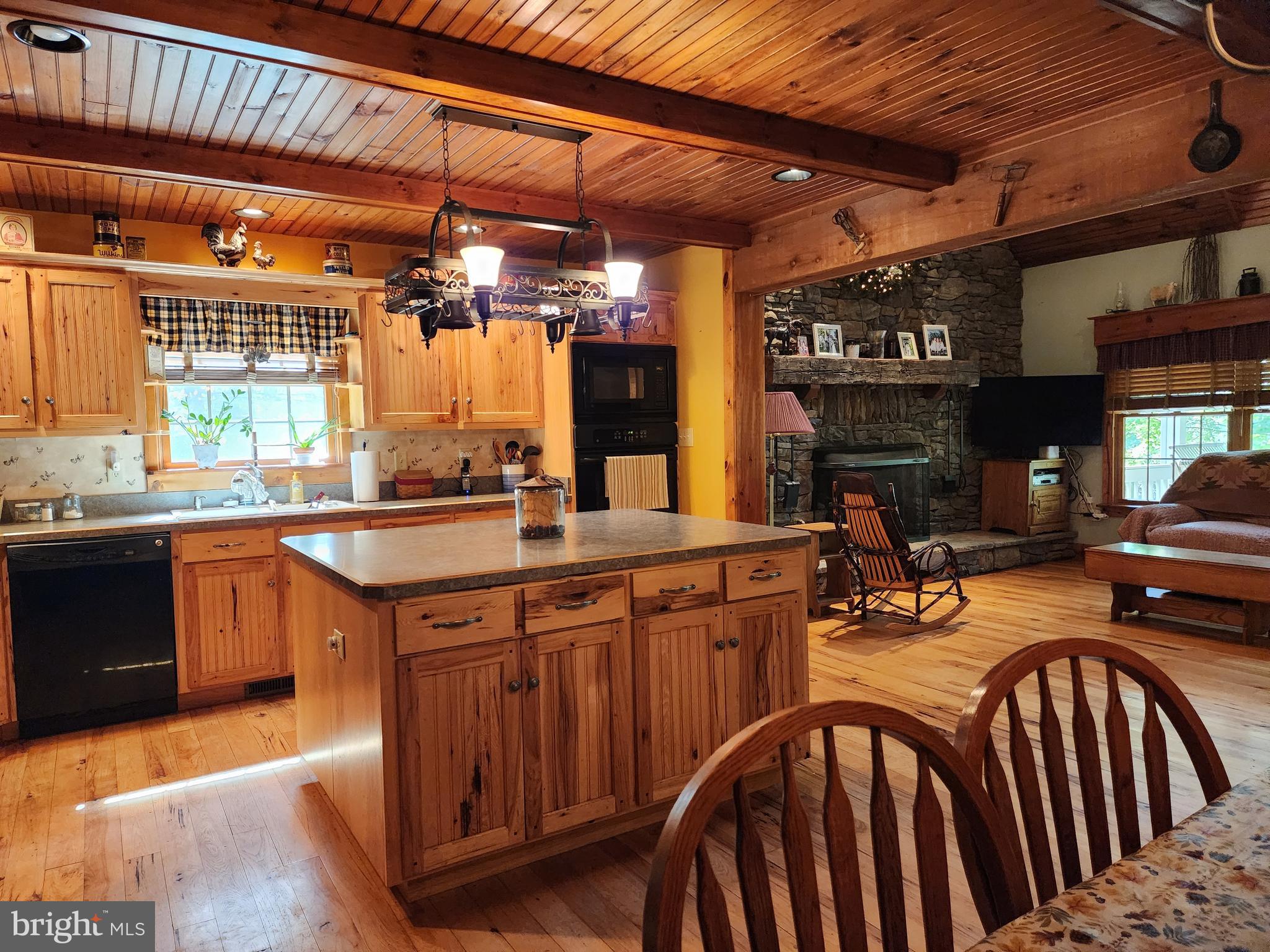 14847 White Oak Ridge Hancock, MD 21750 - Photo 39 of 101 a kitchen with stainless steel appliances granite countertop a sink a stove and wooden cabinets