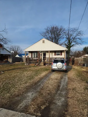 a view of a house with a yard and sitting area