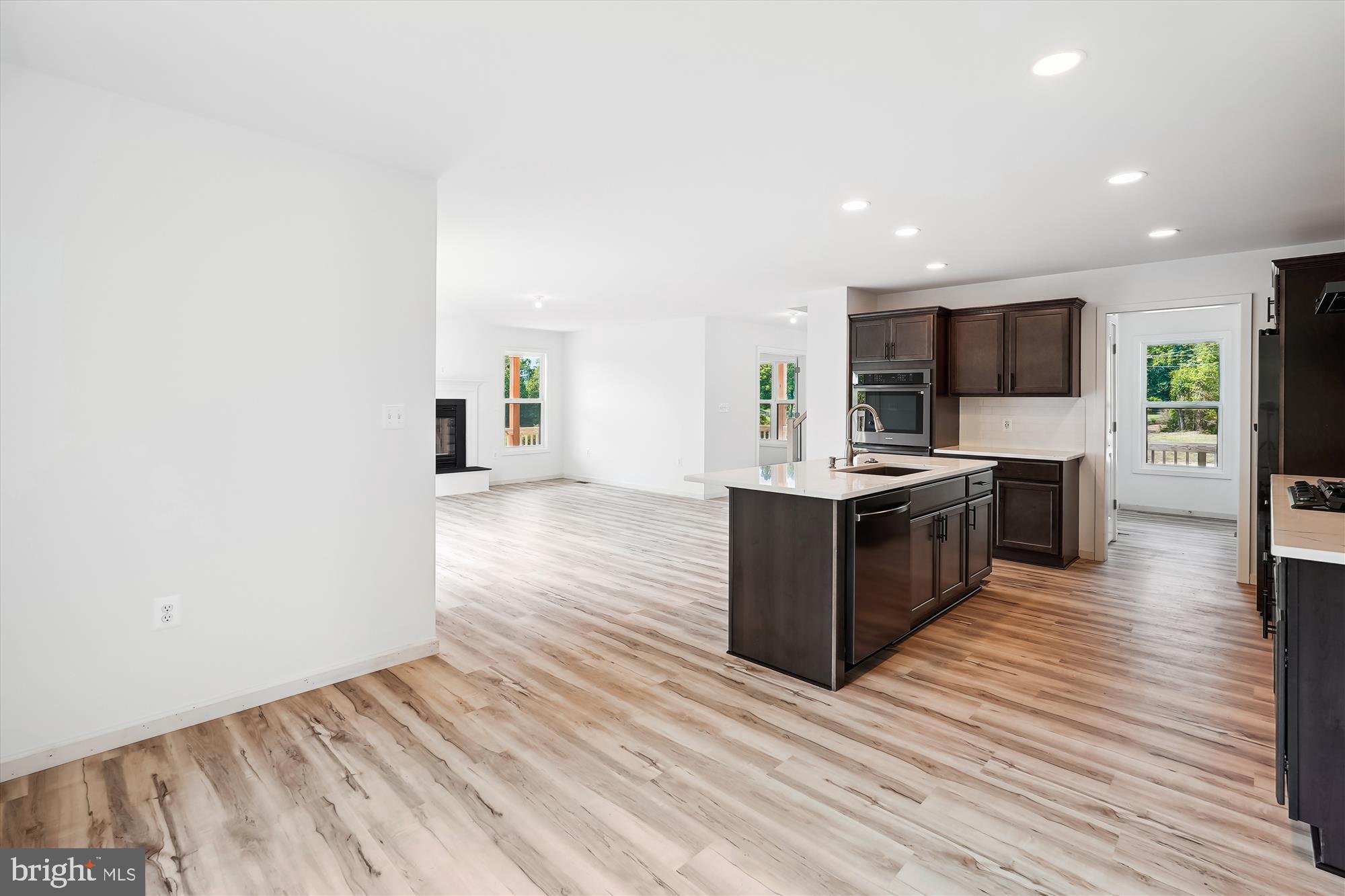 2 Cedar Ridge Road Rapidan, VA 22733 - Photo 14 of 59 a large room with kitchen island stainless steel appliances kitchen island a sink dishwasher a stove and a refrigerator with wooden floor