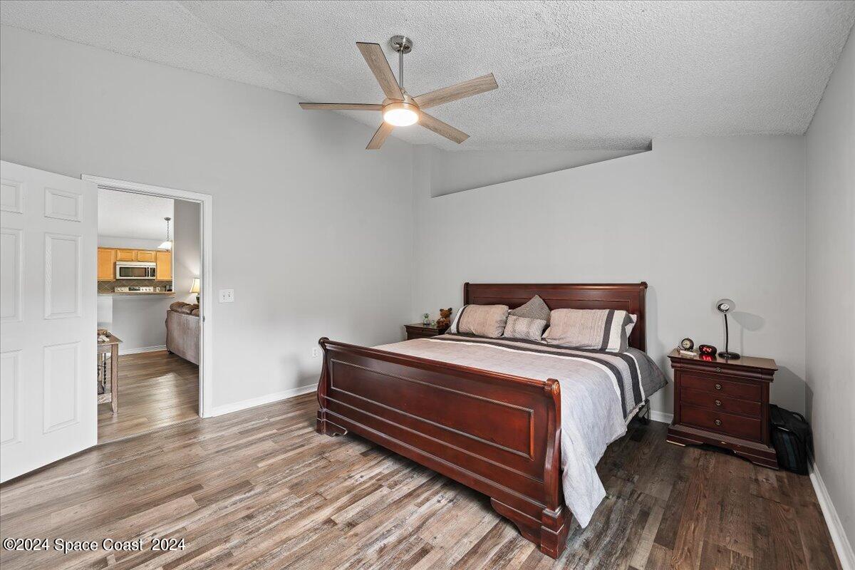 3905 Grand Meadows Boulevard Melbourne, FL 32934 - Photo 12 of 32 a bedroom with a bed and a book shelf