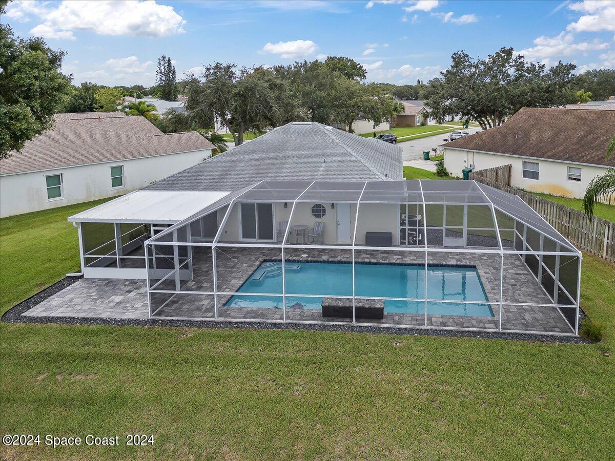 3905 Grand Meadows Boulevard Melbourne, FL 32934 - Photo 2 of 32 a front view of a house with a yard