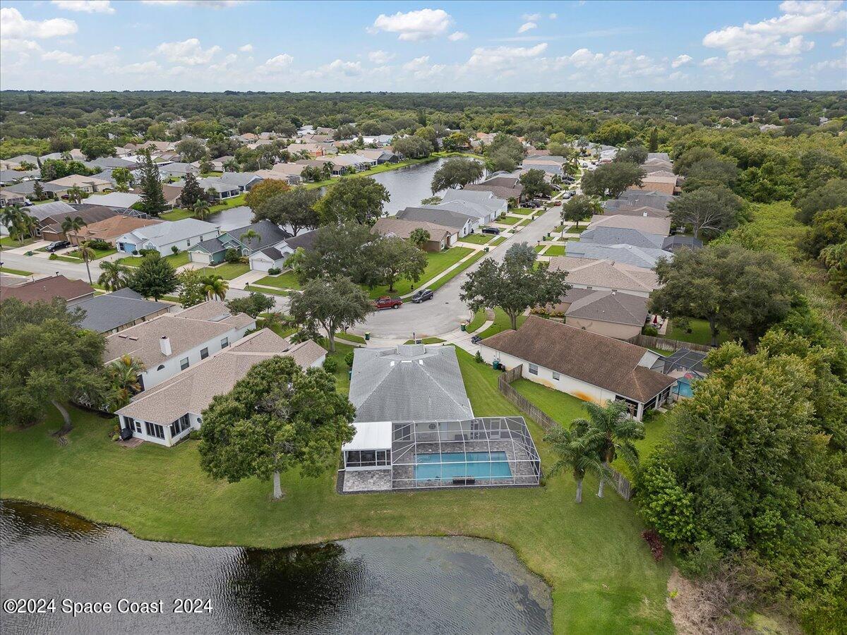 3905 Grand Meadows Boulevard Melbourne, FL 32934 - Photo 28 of 32 an aerial view of residential houses with outdoor space and trees