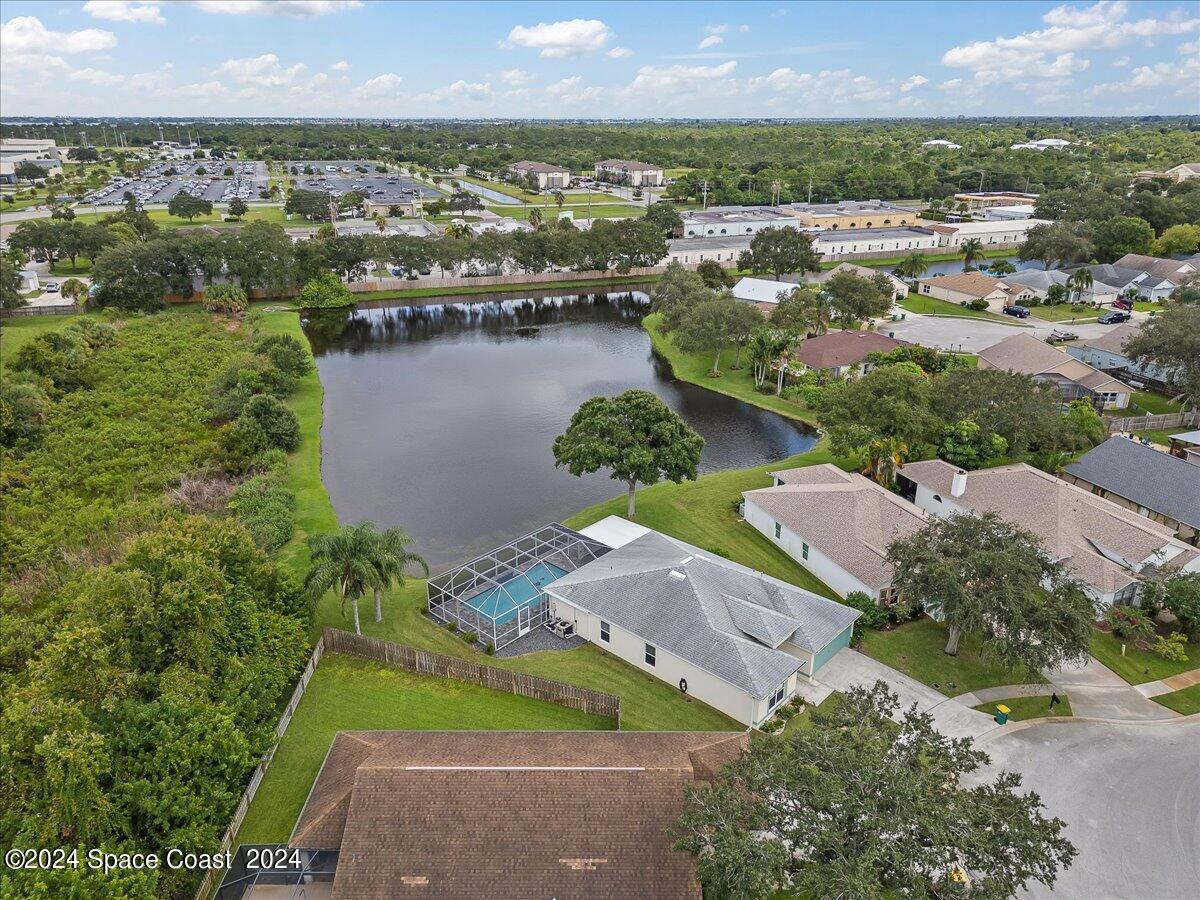 3905 Grand Meadows Boulevard Melbourne, FL 32934 - Photo 30 of 32 an aerial view of lake residential houses with outdoor space and swimming pool