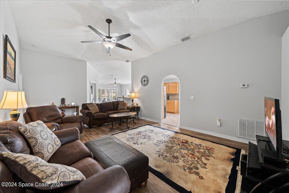 3905 Grand Meadows Boulevard Melbourne, FL 32934 - Photo 4 of 32 a living room with furniture and a flat screen tv
