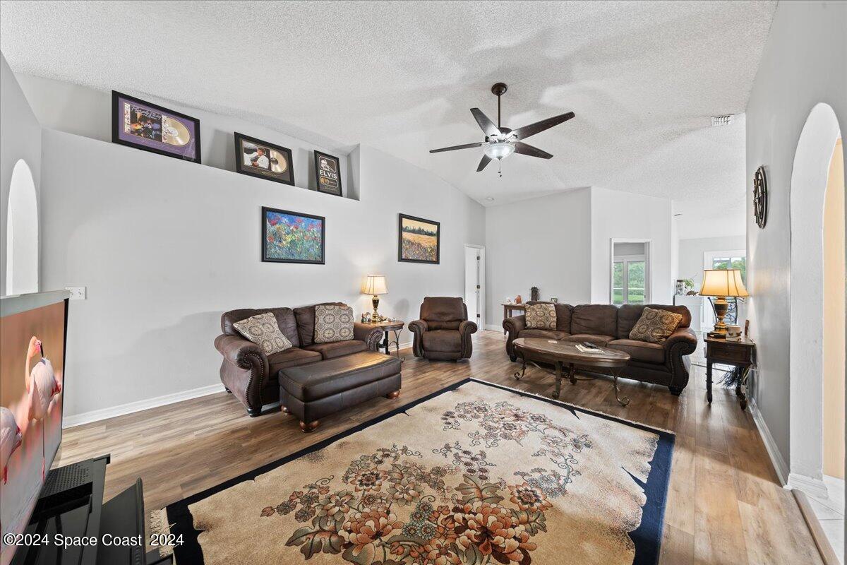 3905 Grand Meadows Boulevard Melbourne, FL 32934 - Photo 5 of 32 a living room with furniture or couch and a flat screen tv